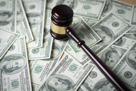 gavel slammed on top of the scattered hundred dollar bills on the table